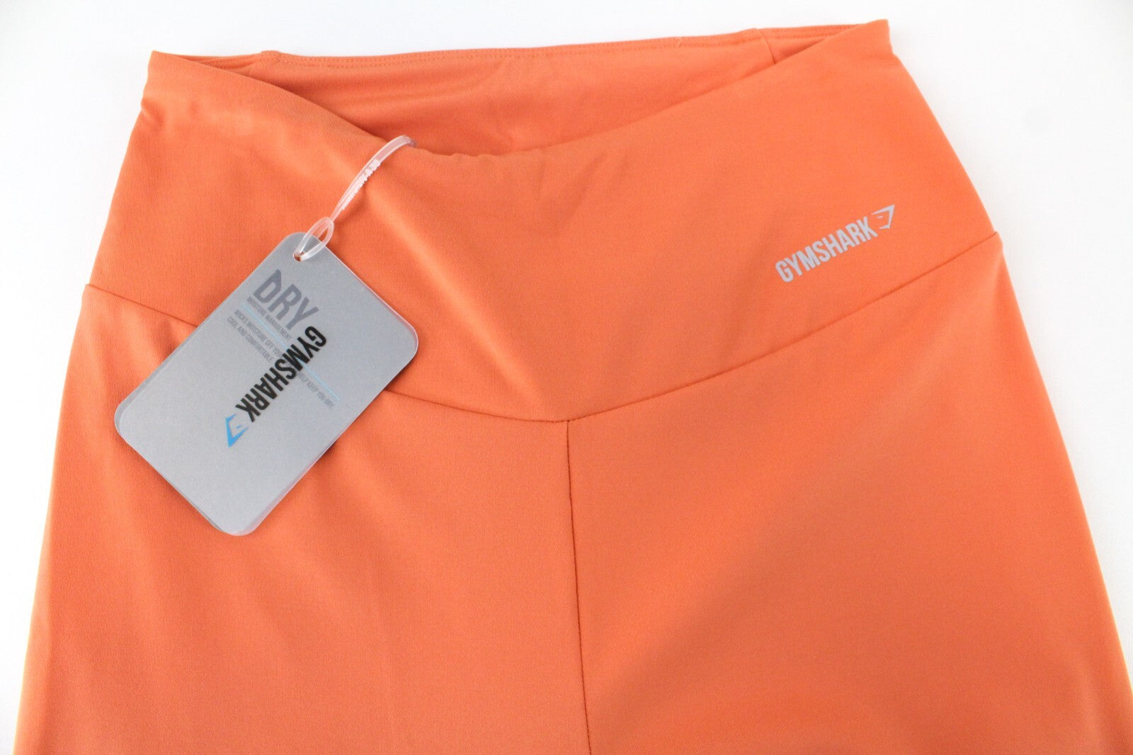 GYMSHARK Pro Perform moteriškos tamprės su oranžine logotipu ir sportine apranga 