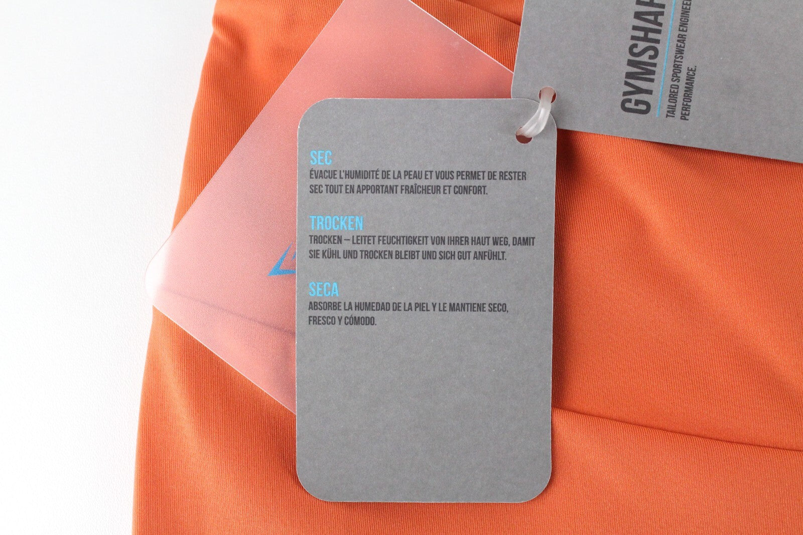GYMSHARK Pro Perform moteriškos tamprės su oranžine logotipu ir sportine apranga 