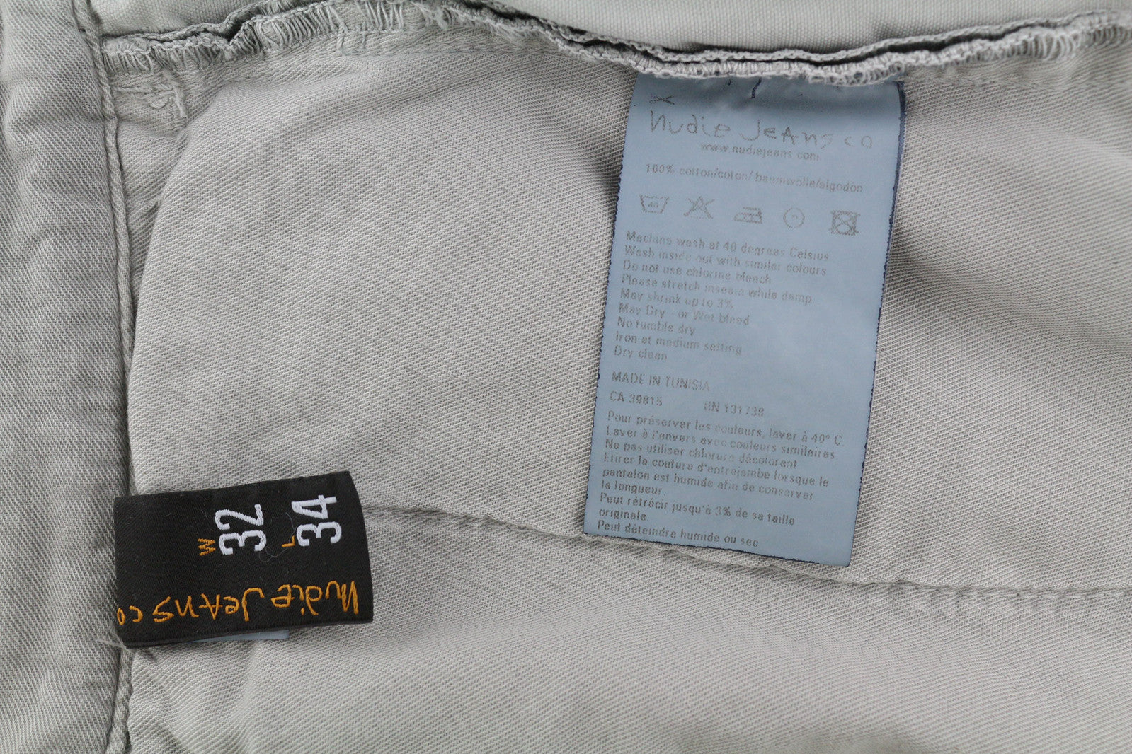 NUDIE JEANS chaki spalvos įprastos vyriškos kelnės W32/L34 organinės medvilnės „Moon Dust“ chino spalvos 