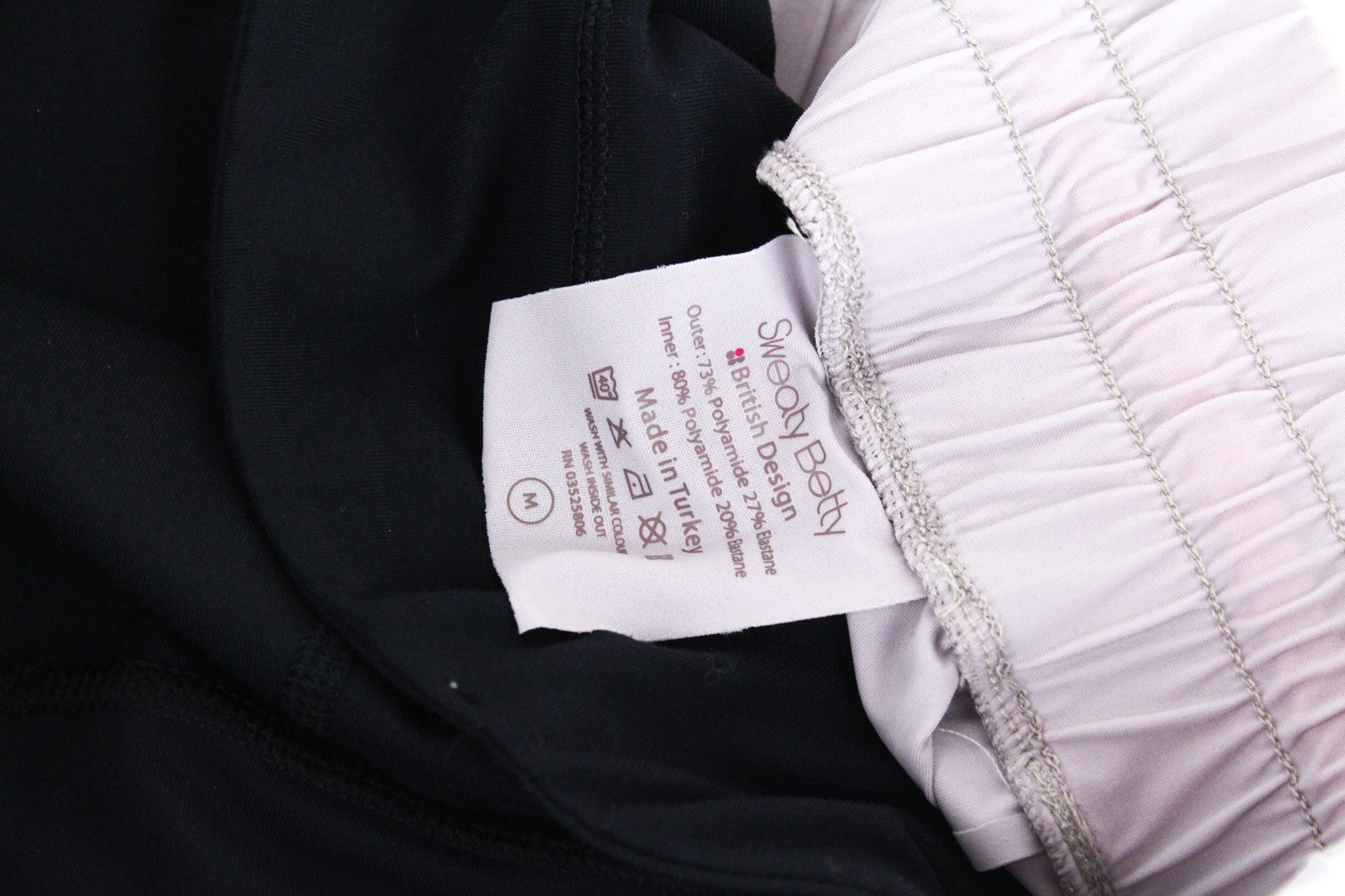 SWEATY BETTY Aerial 2in1 moteriški šortai M violetiniai juodi sportinės aprangos tamprūs logotipai 