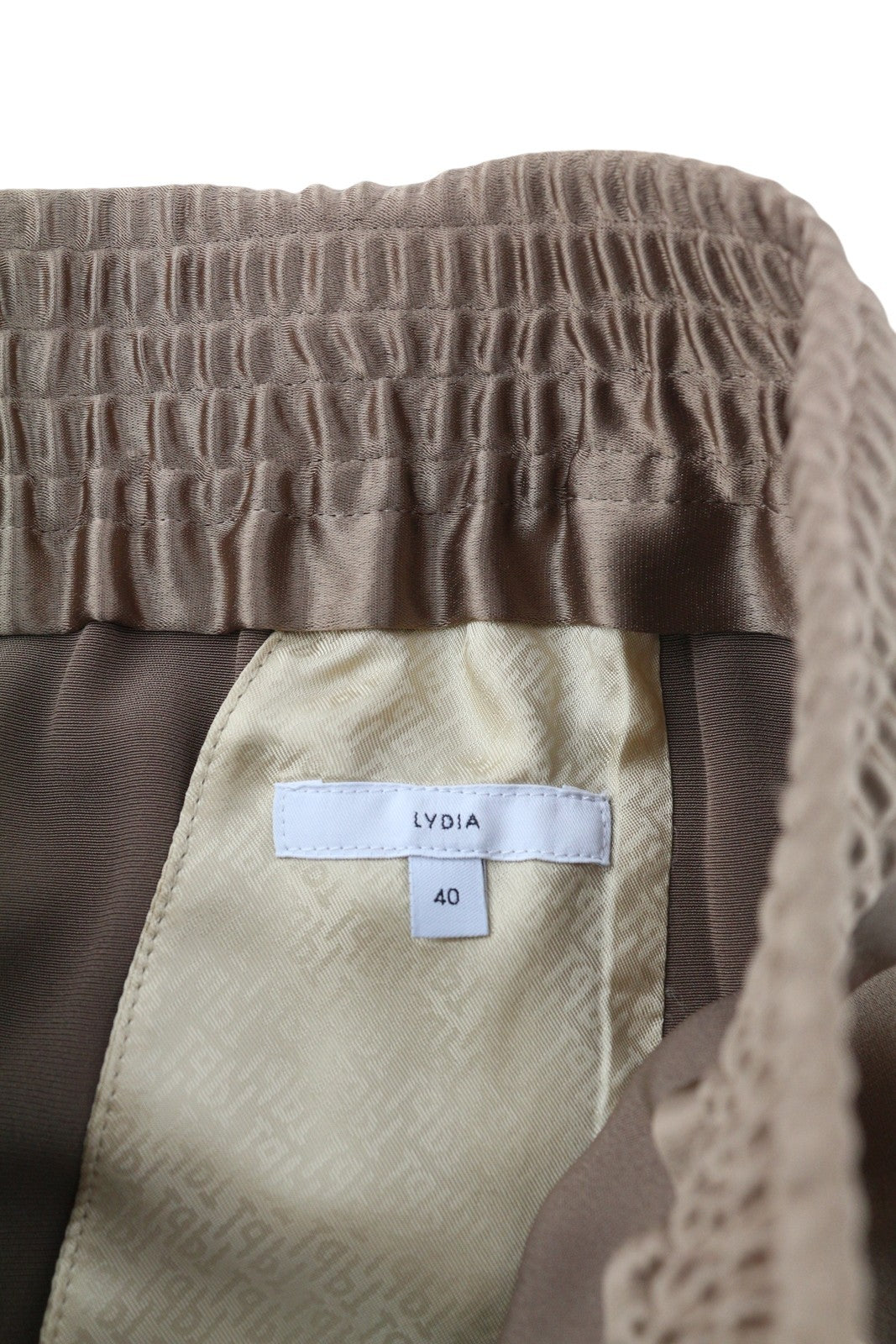 PT TORINO Lydia moteriškos kelnės, 40 dydis, rudos, blizgios, tamprios juosmens, platėjančios kišenės kojose. 