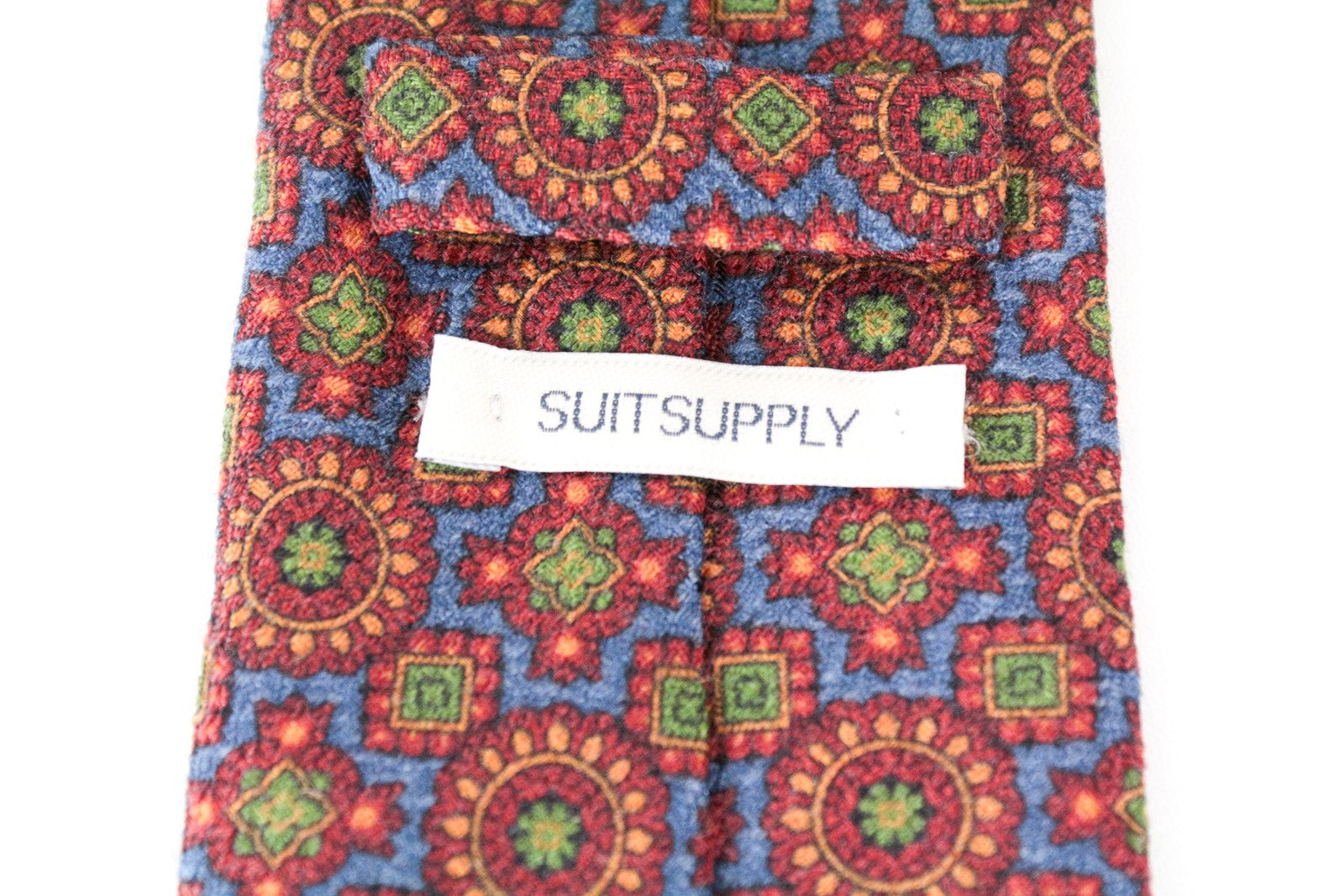 SUITSUPPLY vyriškas kaklaraištis ~150x8,5 raudonai mėlynas raštuotas vilnonis šilkas smailiais galais 