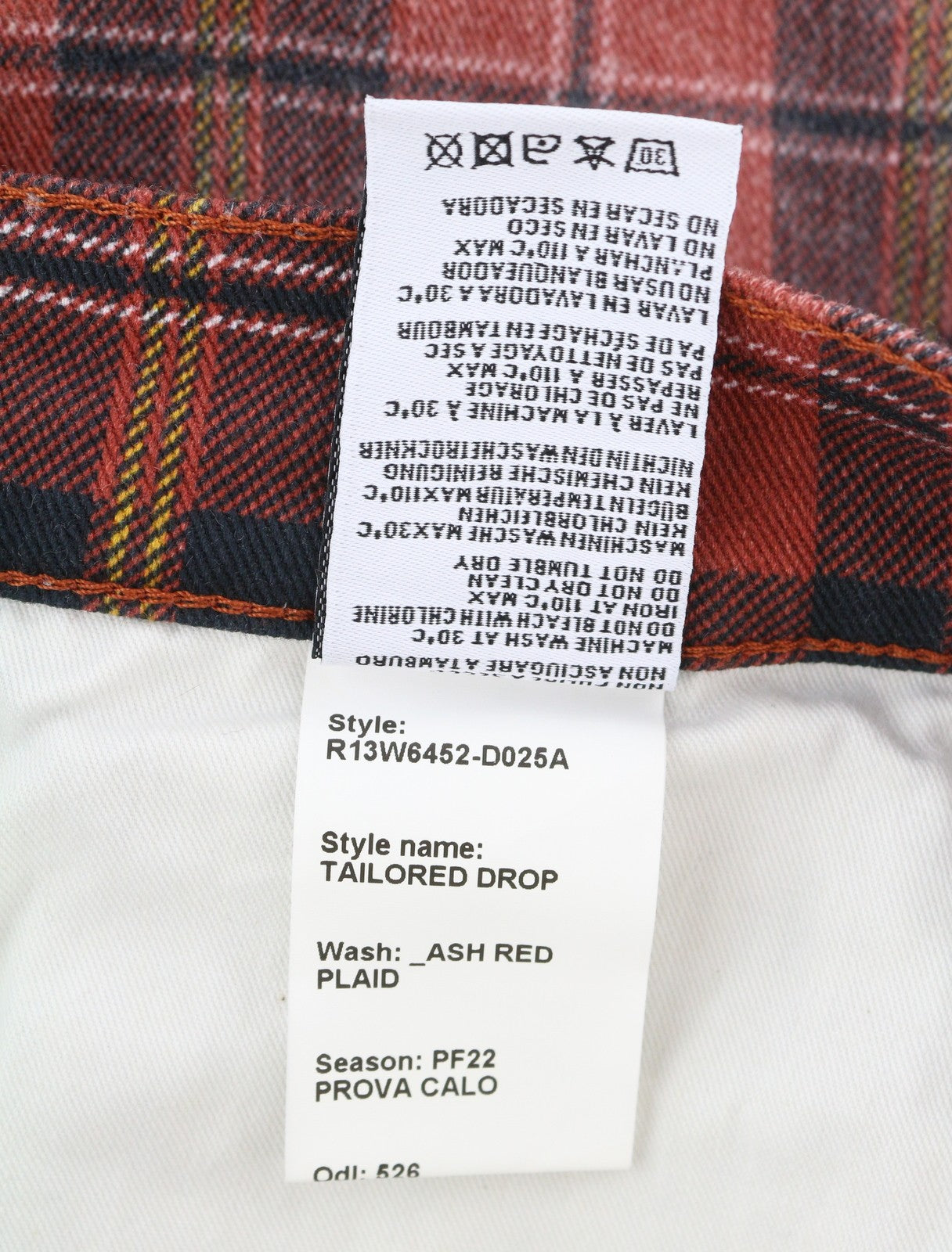 R13 Pasiūtos moteriškos kelnės 27 pelenų raudonumo, languotos, trumpintos, nuleistos iki kulkšnies ir tarpkojo. 