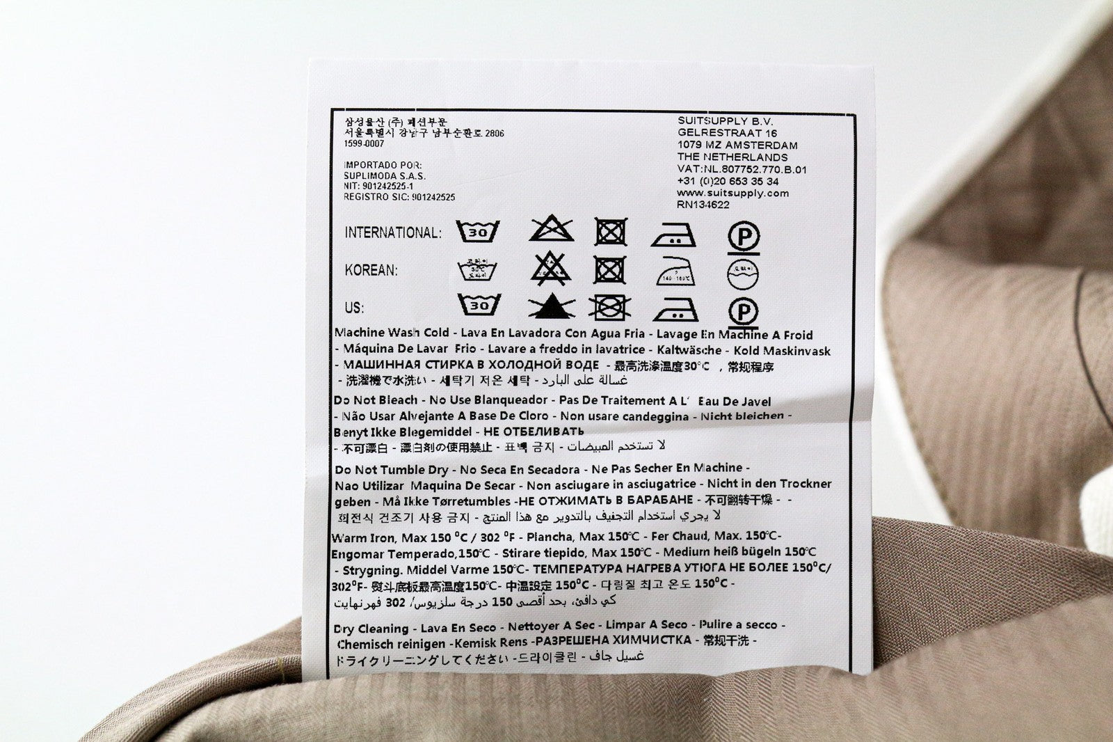 SUITSUPPLY Braddon vyriškos klostuotos kelnės iš UK38R, balkšvos, tamprios medvilnės 